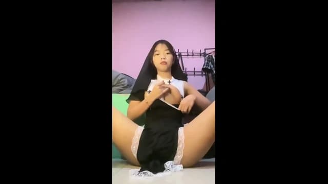 Asian cutie rubbing her cunt in sexy nun costume